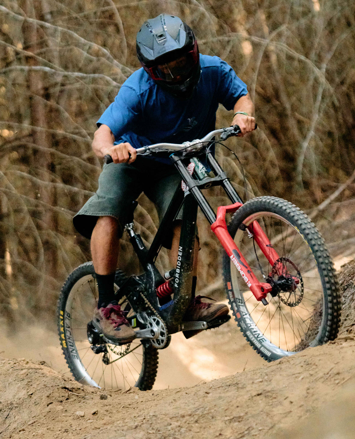 Person riding a mountain bike on a dirt trail with a blurred background