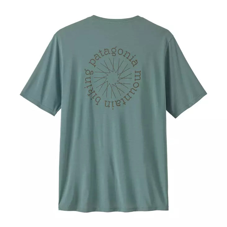 A sage green Patagonia short-sleeve t-shirt shown from the back, featuring a circular graphic with a sunburst and the brand name printed in a matching tone.