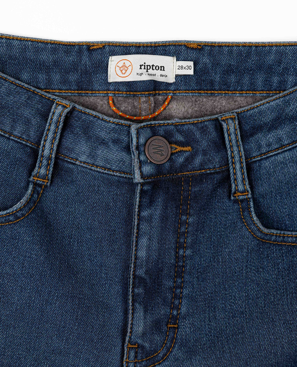 Close-up of blue jeans with a Ripton label on a white background
