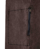 Close-up of a brown fabric pocket with a zipper on a white background