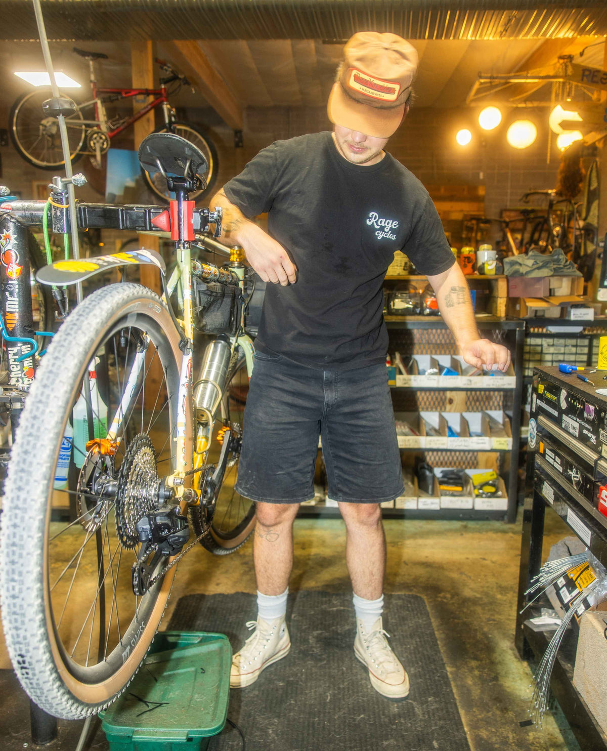 Person working on a bicycle in a workshop setting