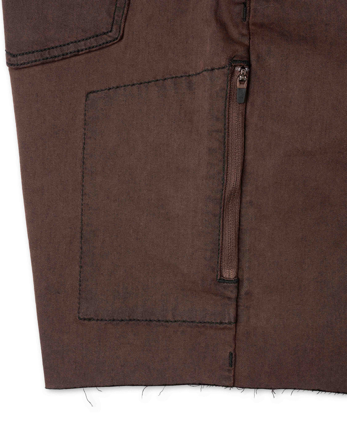 Close-up of brown fabric with a zipper pocket on a white background