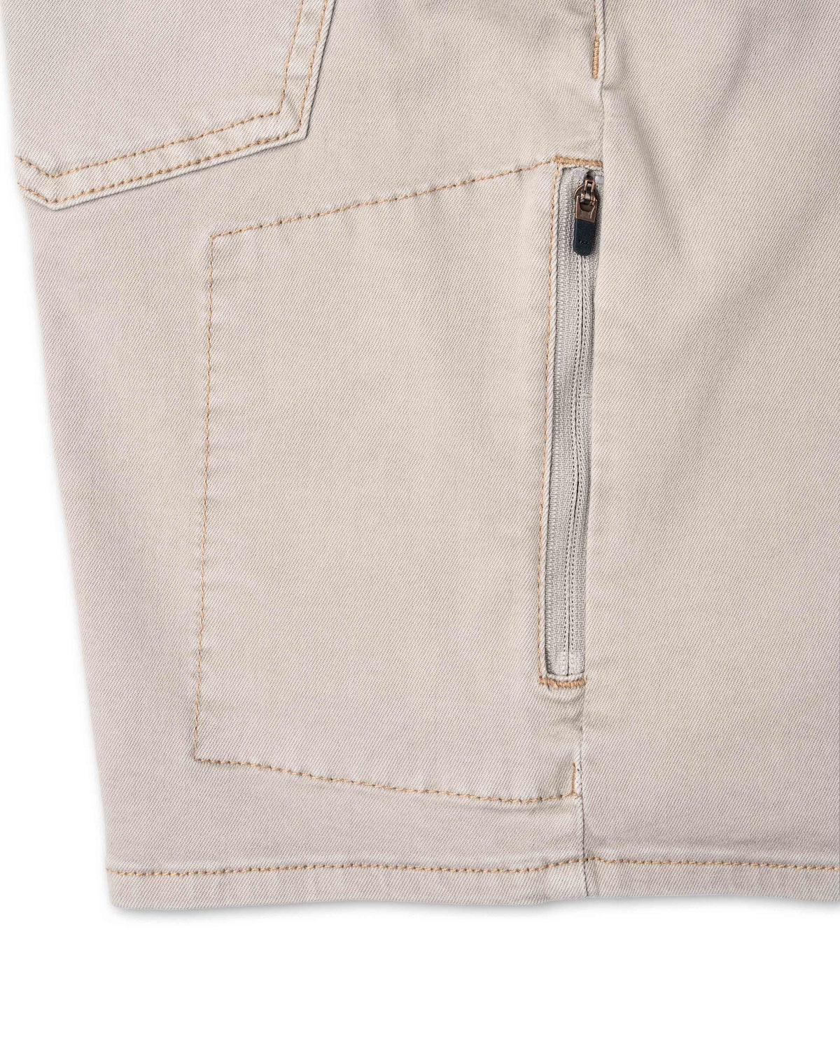Close-up of beige shorts with a zipper on a white background