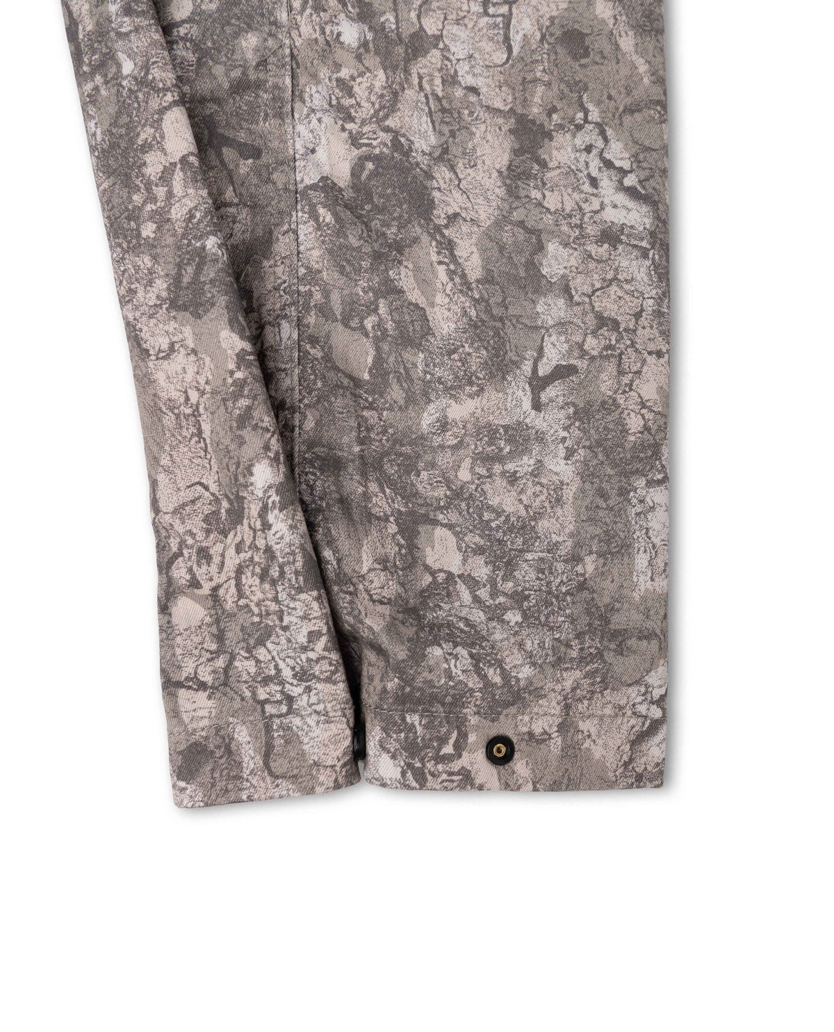 Close-up of a gray and beige camouflage-patterned fabric sleeve with a single dark button at the cuff, shown against a plain white background.