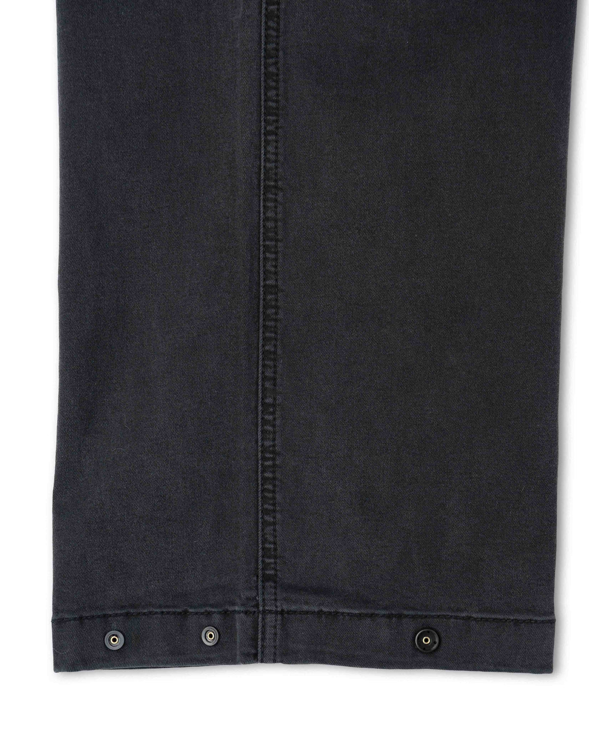 Close-up of a black denim jacket with button details on a white background