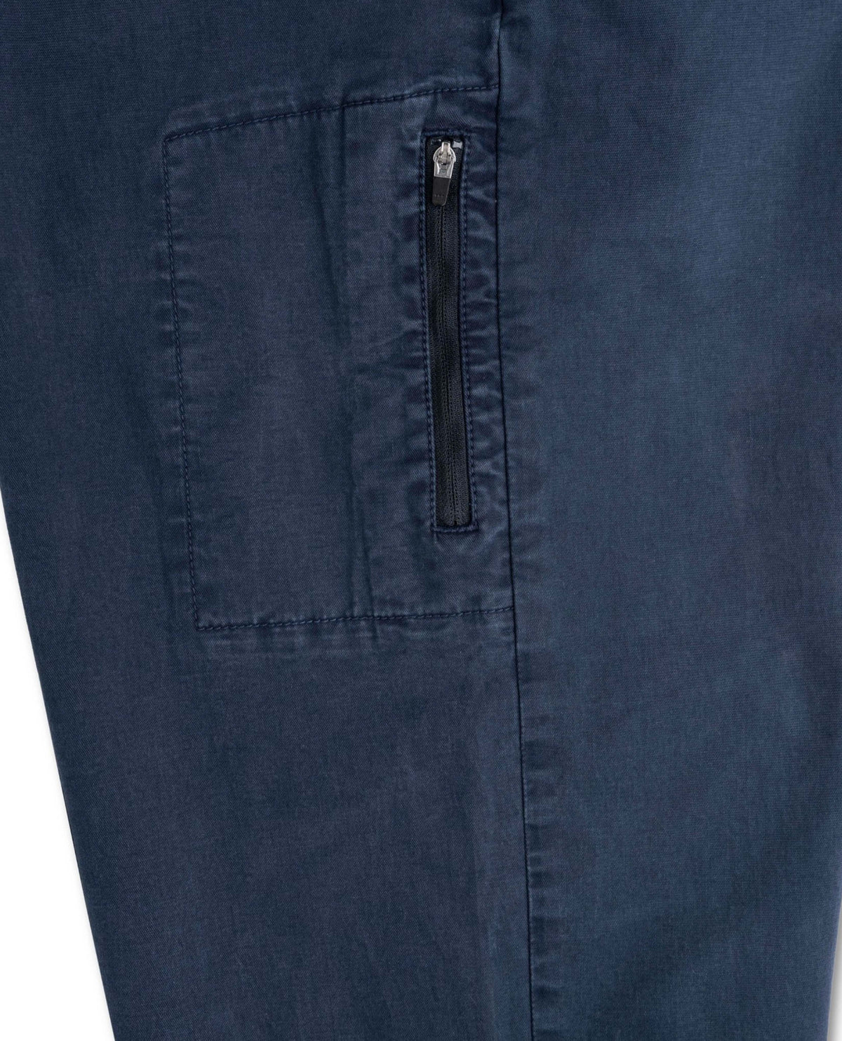 Close-up of a navy blue fabric with a pocket and zipper detail.