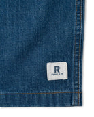 Close-up of a blue denim fabric with a Ripton & Co. label.
