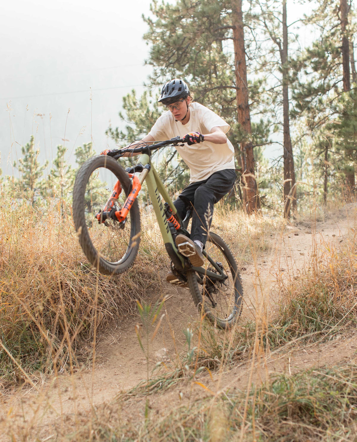 Hadrien doing a wheelie in Superlite jeans
