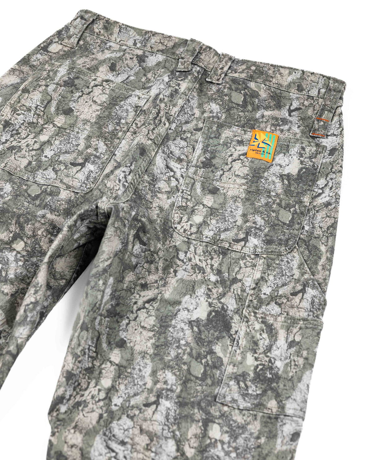 Camouflage pants with a brand logo on a white background