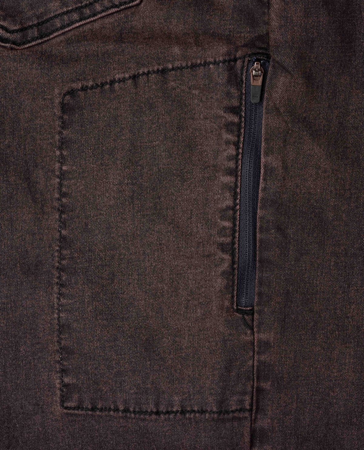 Close-up of a dark brown fabric with a zipper pocket