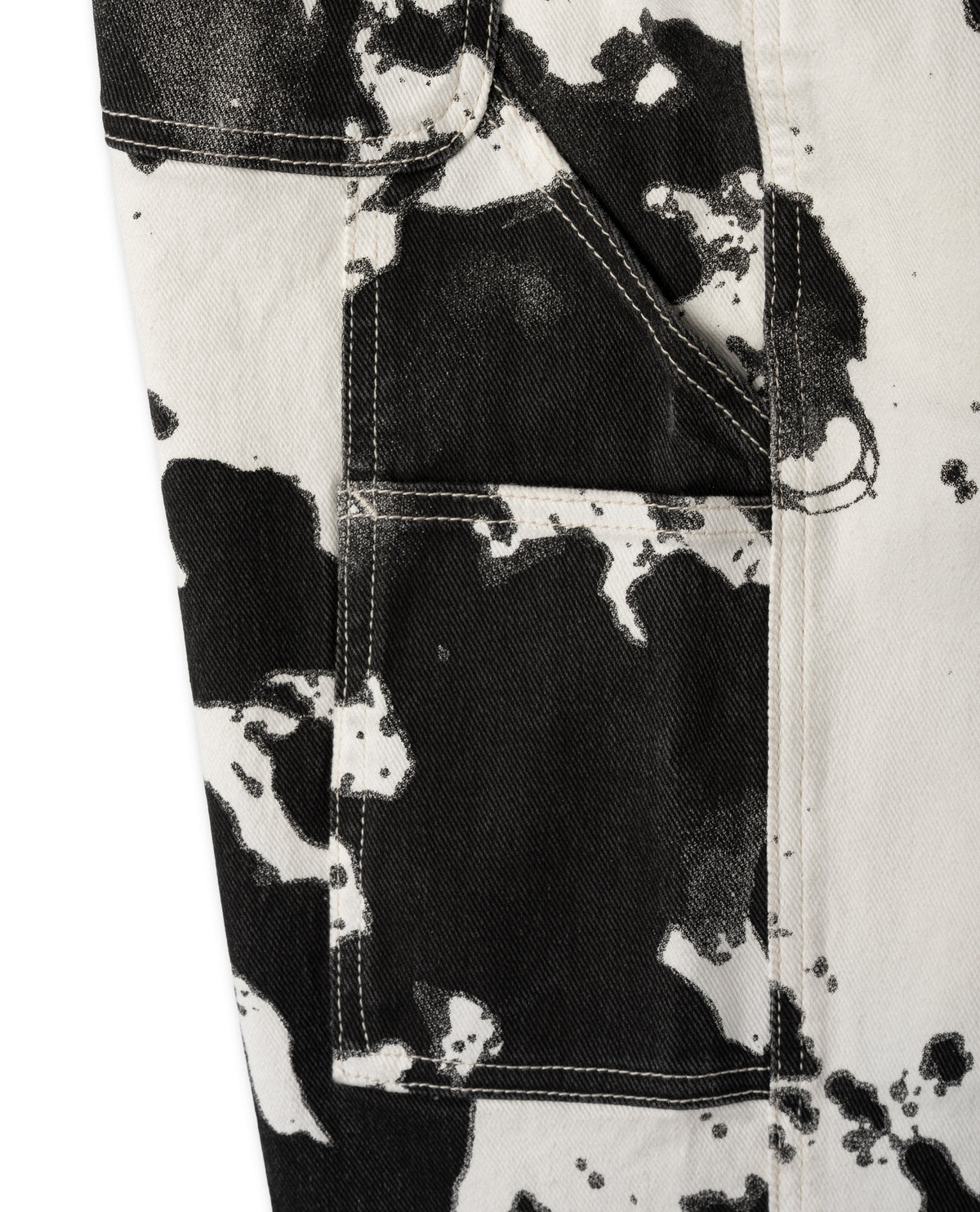 Close-up of a black and white patterned fabric with a pocket detail.