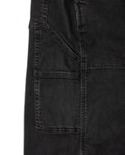 Close-up of a black denim jacket with pocket details on a white background