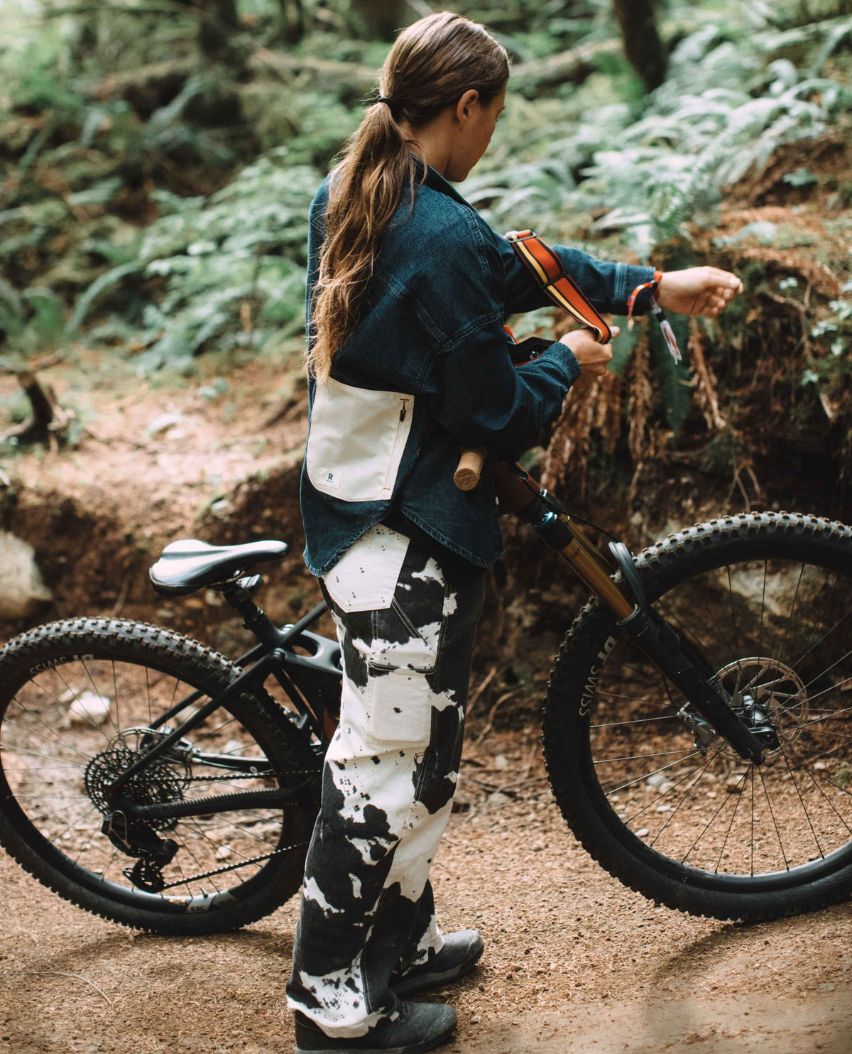 Person with a mountain bike in a forest setting