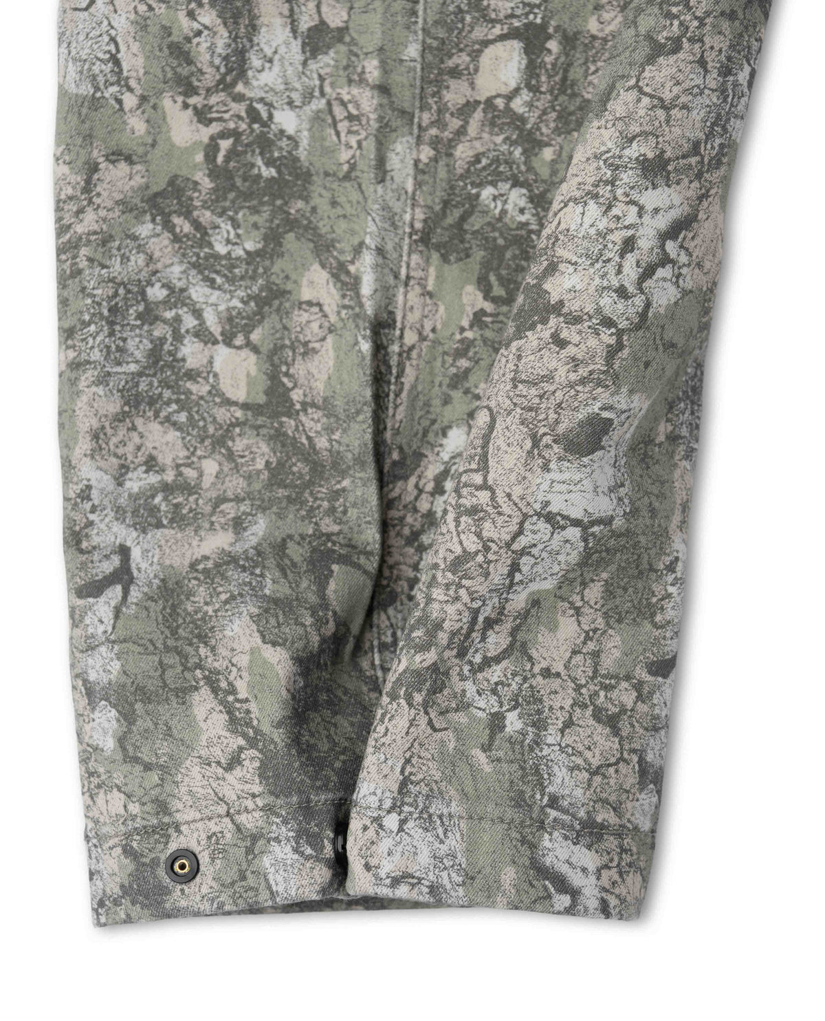 Close-up of camouflage pants with a detailed pattern on a white background