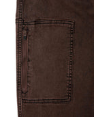 Close-up of a brown pocket on a garment with a white background