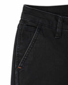 Close-up of black jeans with a white background