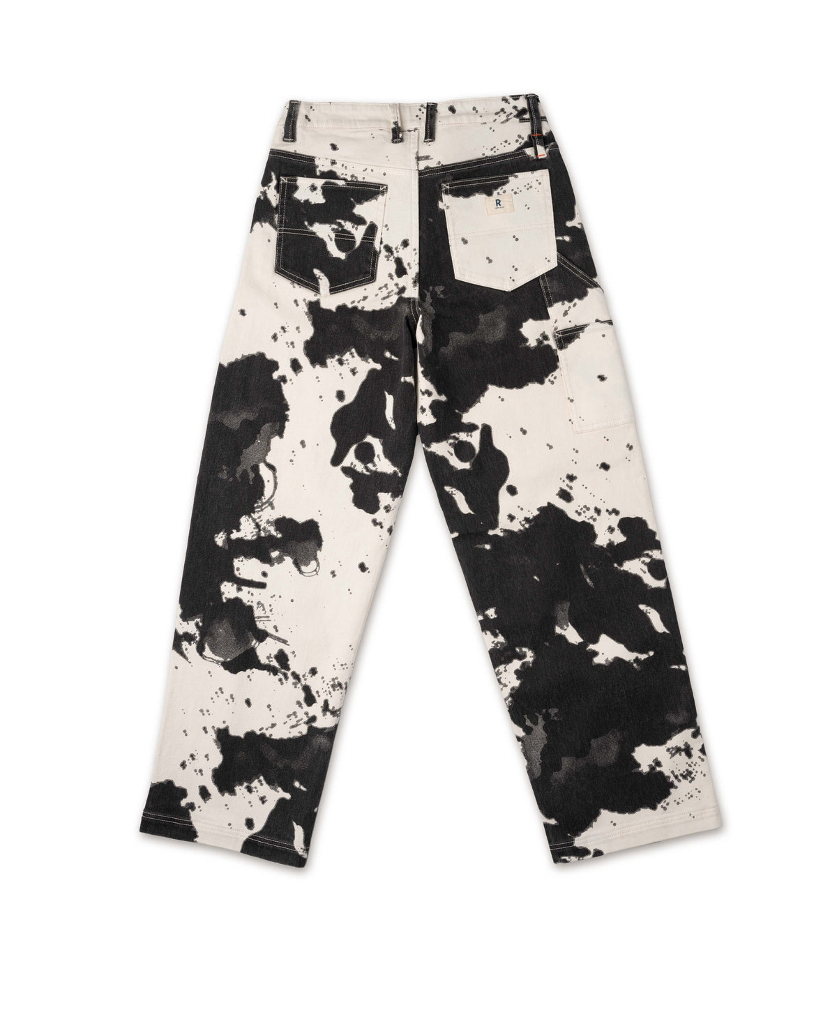 Black and white splatter paint pants on a white background