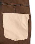 Close-up of a brown denim jacket with a beige pocket on a white background