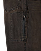 Close-up of dark brown denim pants with a zipper pocket on a white background