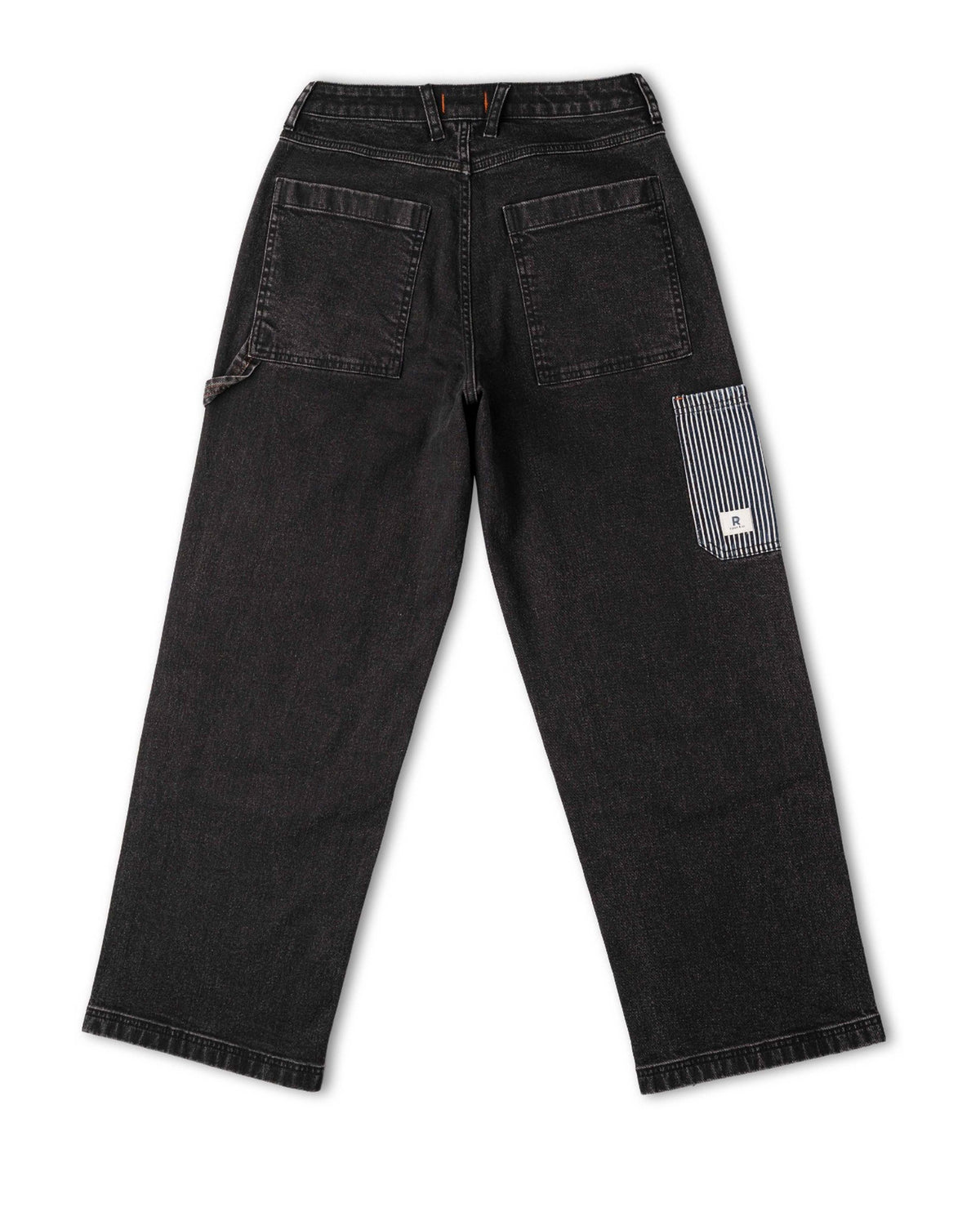 Black jeans with a patch on the back pocket on a white background