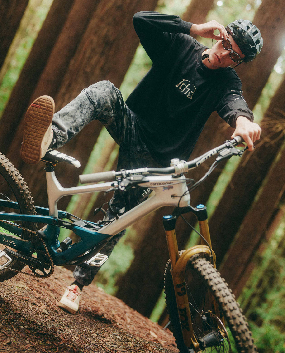Person riding a mountain bike on a rocky trail in a forest