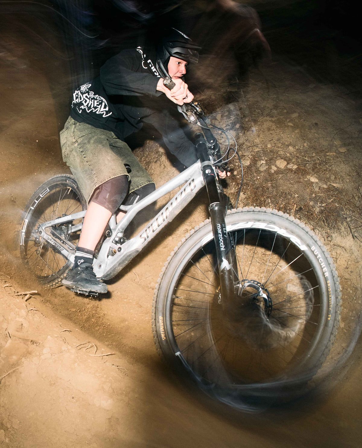 Person riding a mountain bike on a dirt trail with motion blur effect