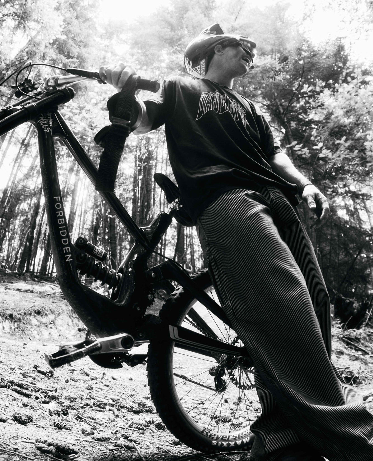 Person with a mountain bike in a forest setting